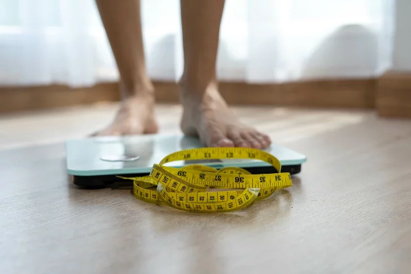 Women stand on electronic scales